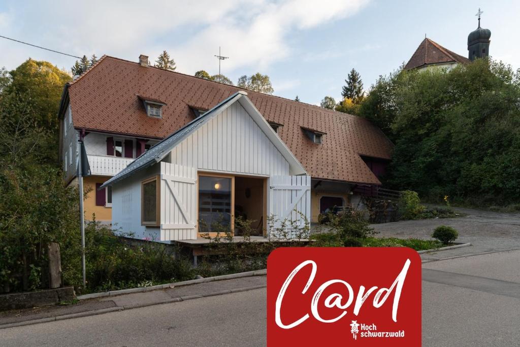 a cocacola sign in front of a house at Tiny House Amélie in Bonndorf im Schwarzwald