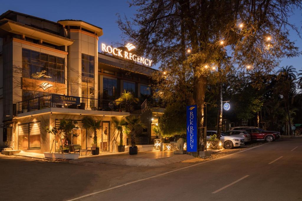 a building with a sign that reads rock benefit at night at Hotel Rock Regency Mount Abu - A Boutique Rodetel in Mount Ābu