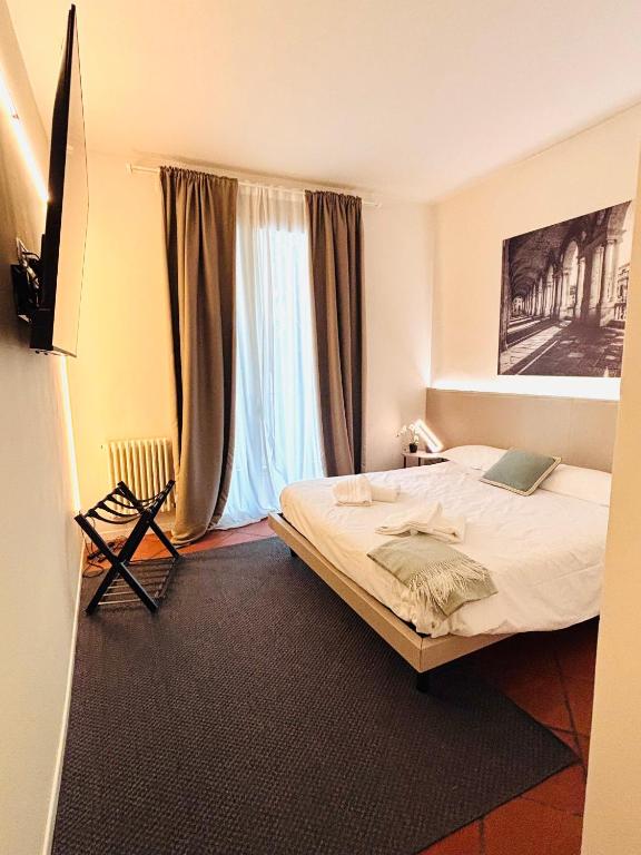 a bedroom with a bed and a large window at Private Terrace Cozy Flat near Vicenza Center in Vicenza