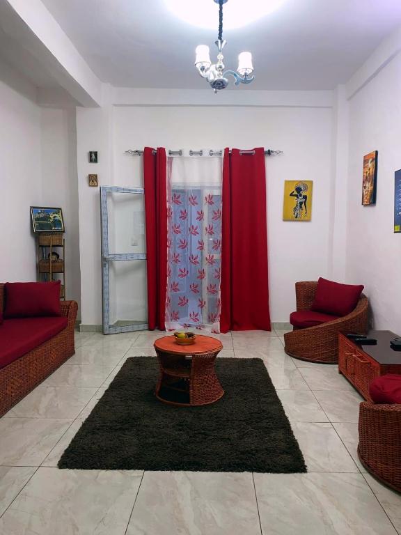 a living room with two couches and a table at Meublé de toursime L'Escale in Yaoundé