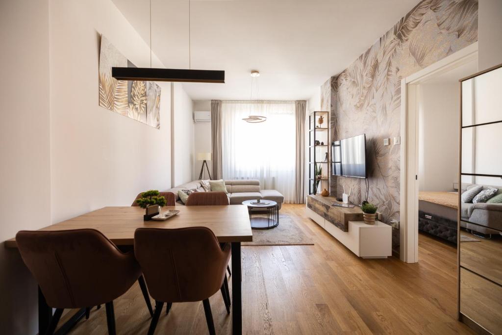 a living room with a dining room table and a couch at Liman 5 Riverside 209 i 109 with Free Private Parking in Novi Sad