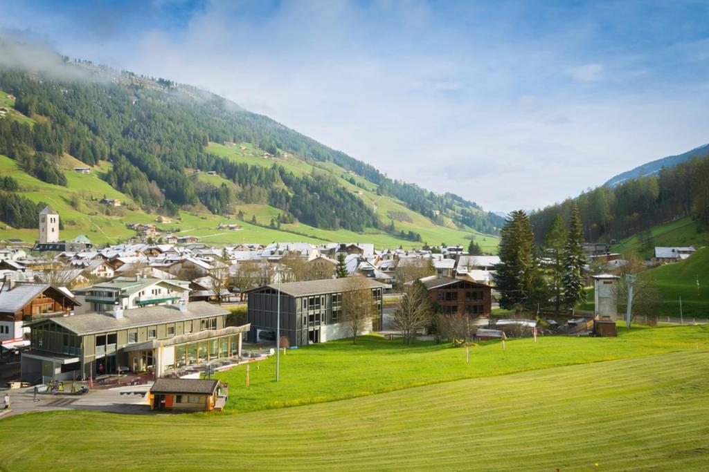a small town in a valley with a mountain at Kersh Dolomites Lodge in San Candido