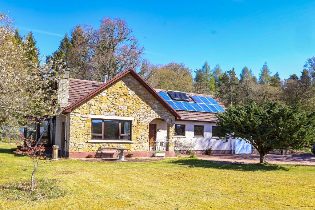 a house with solar panels on the roof at Ardmara in Belladrum