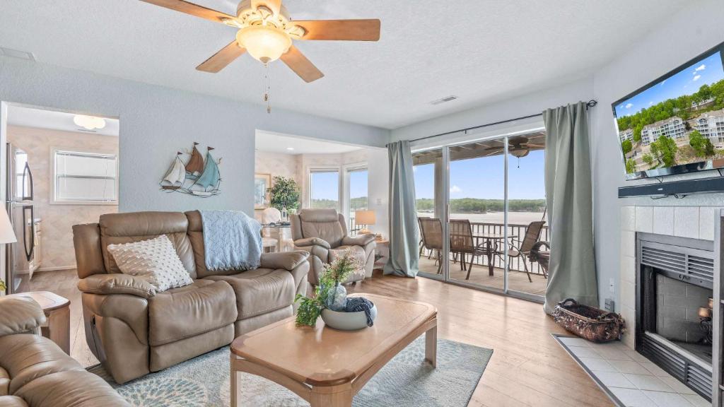 a living room with a couch and a fireplace at By The Lake Resort Access in Lake Ozark