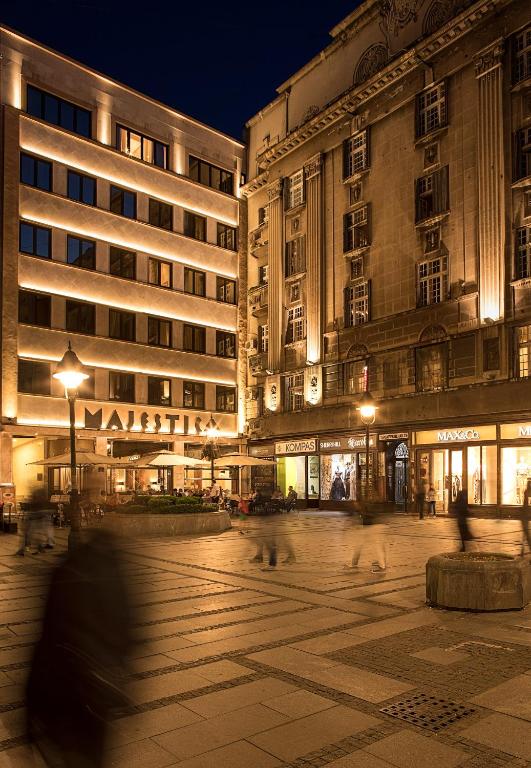 a group of birds walking in front of a building at Hotel Majestic in Belgrade