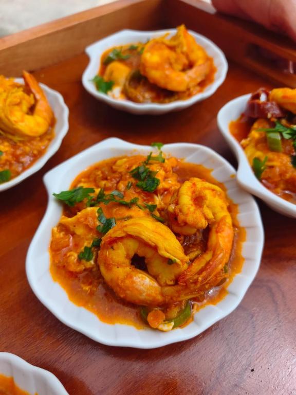 a table topped with plates of food with shrimp at Beit El Ezz - Les Suites in Ouled Yaneg