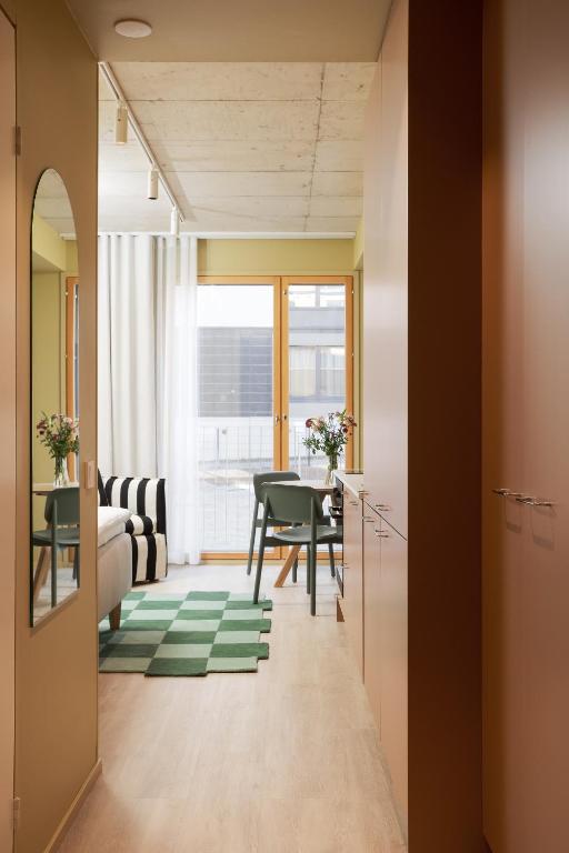 a living room with a table and a dining room at Aarni Property in Jyväskylä