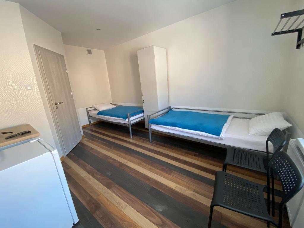 a small room with a bed and a table and chairs at Noclegi in Starachowice