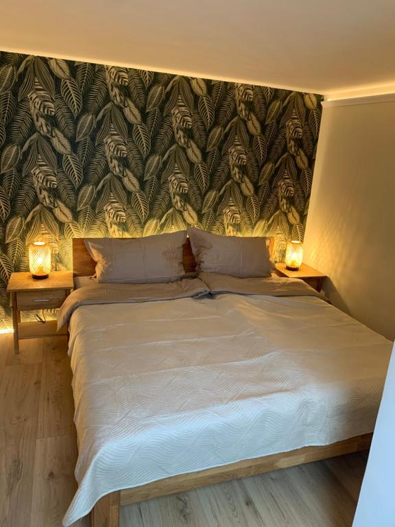 a bedroom with a large bed with two night stands at Kurzeit 38 in Bad Nenndorf