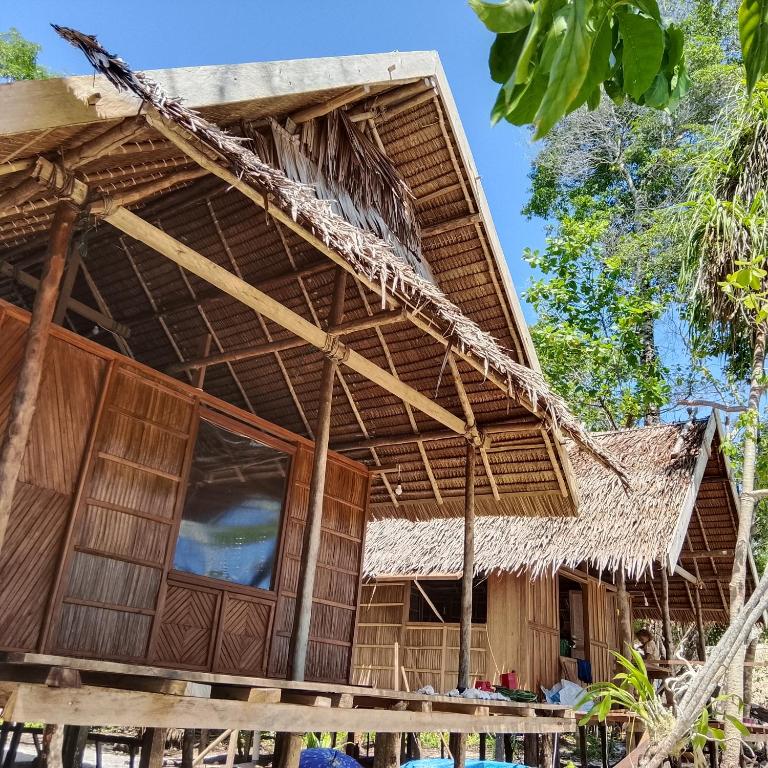 a bamboo building with a thatched roof at Batanta Explorers in Pulau Saonek-kecil