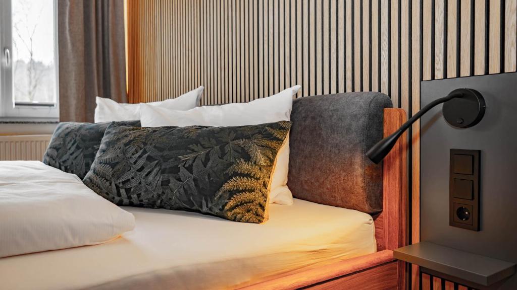 a bed with a pillow and a lamp on it at Hueber der Wirt in Sankt Georgen an der Leys
