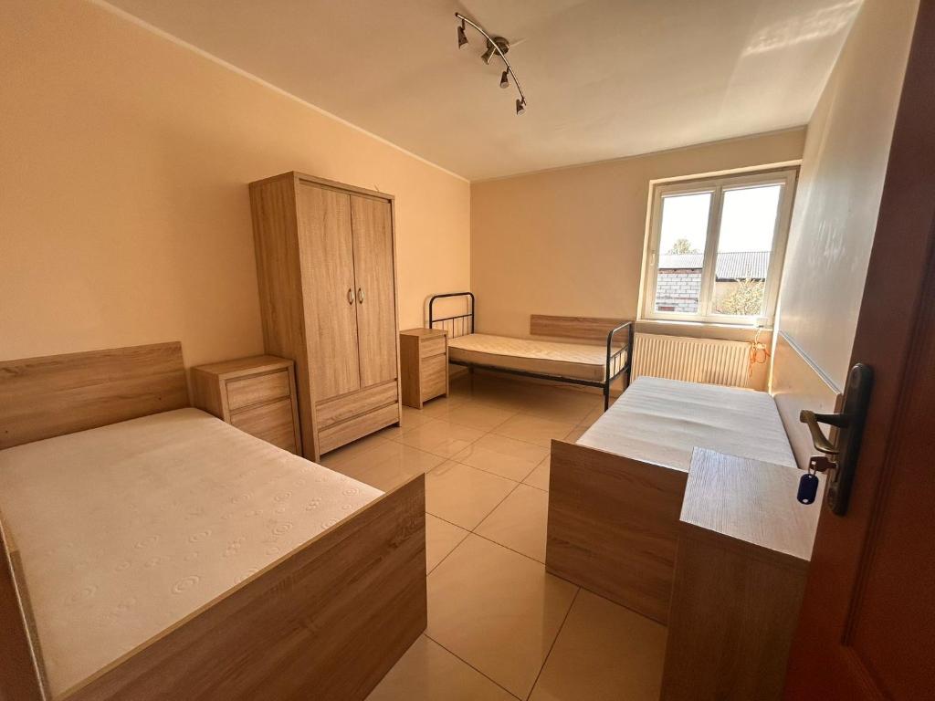 a hospital room with two beds and a window at Hostel Jagiellońska in Nowe Miasto Lubawskie