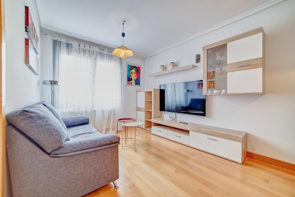 a living room with a couch and a television at Las Gaunas by Clabao in Logroño