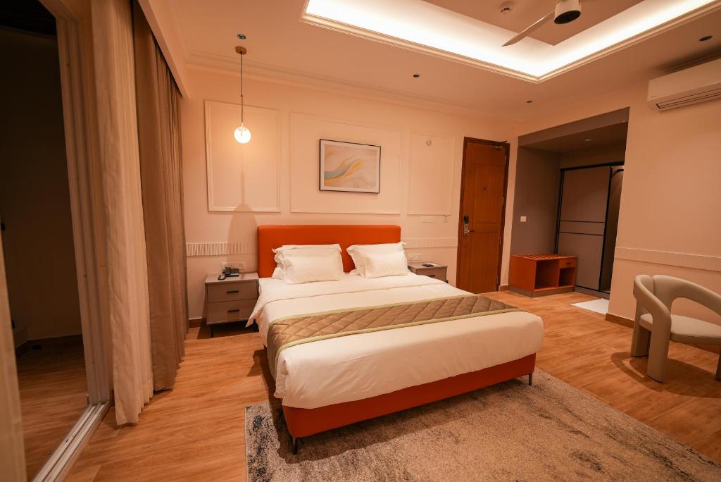 a bedroom with a large bed in a room at Hotel California in Bangalore