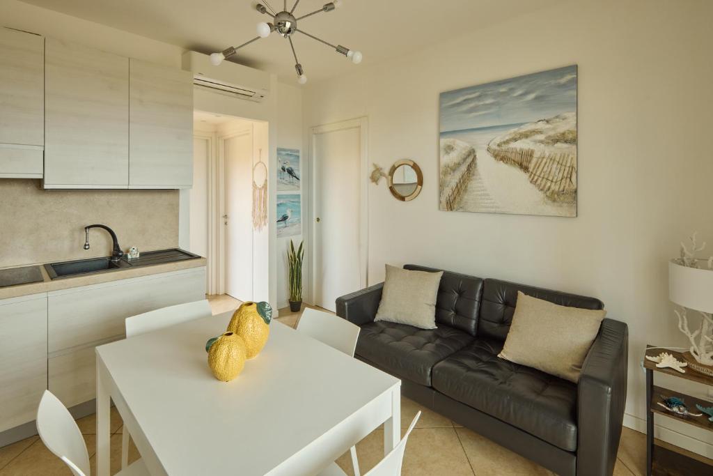 a living room with a white table and a couch at Badesi Sea Dunes in Codaruina
