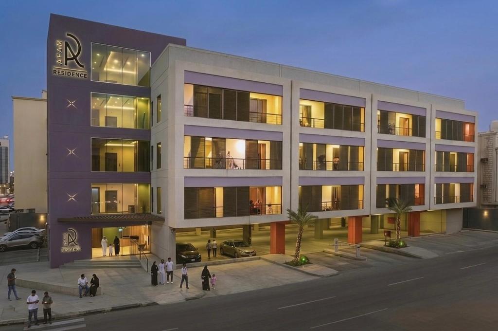 a large building with people standing outside of it at AFAM Residence in Dammam