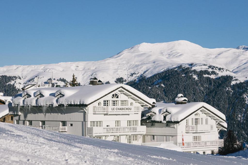 a large white building with snow on top of a mountain at Le Chabichou Hotel & Spa in Courchevel