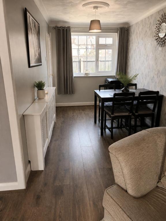 a living room with a table and a dining room at The Grimsby Heneage Stay in Grimsby