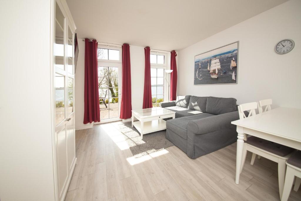 a living room with a couch and a table at Schleiblick App 9 in Rabenkirchen-Faulück