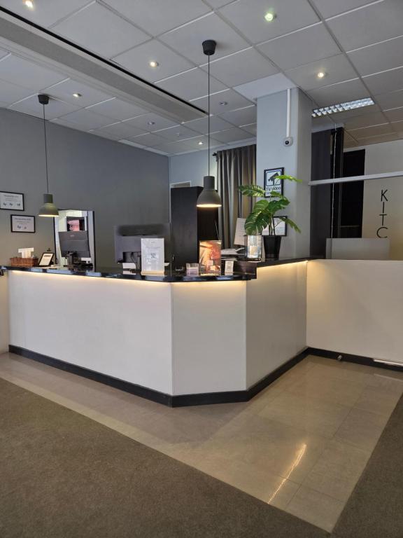 a lobby with a white counter in a building at Hotell Centralstation in Uppsala