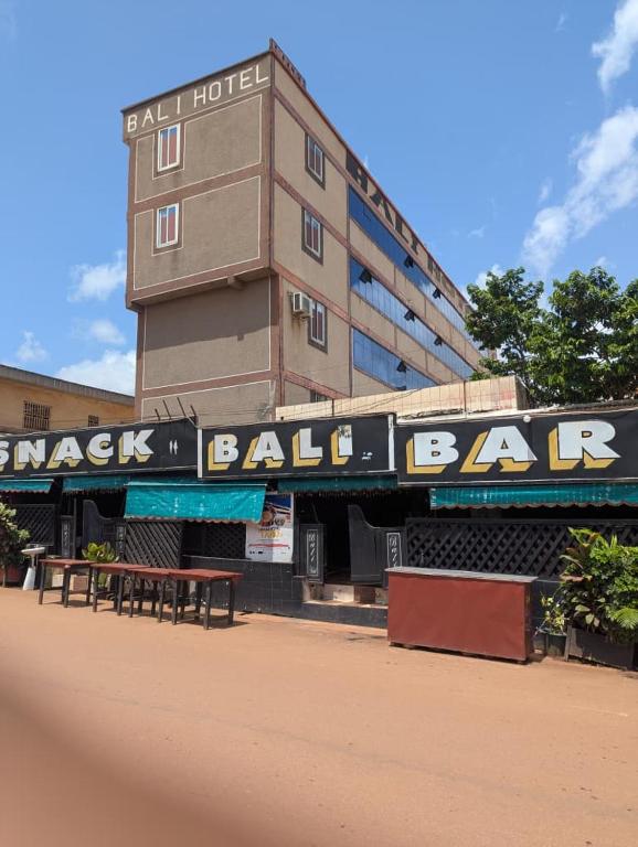 a building with a sign for a baseball ball bar at BALI HOTEl in Yaoundé