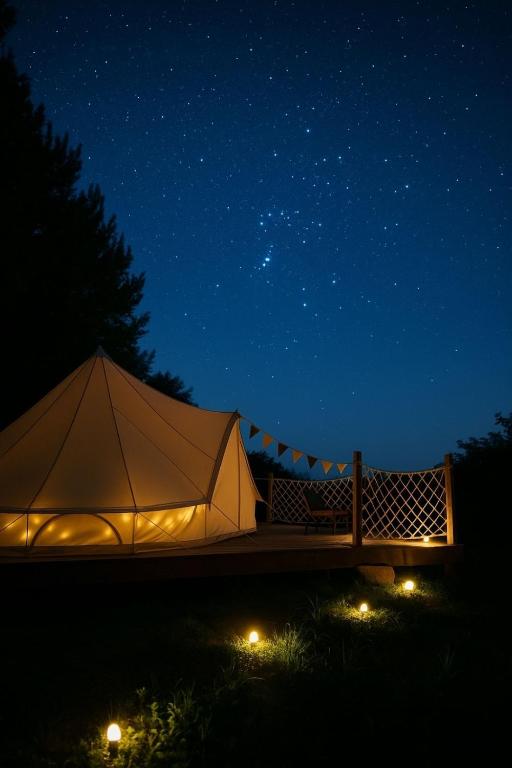 a tent with lights in a field at night at Glamping Ty Západy in Stanový