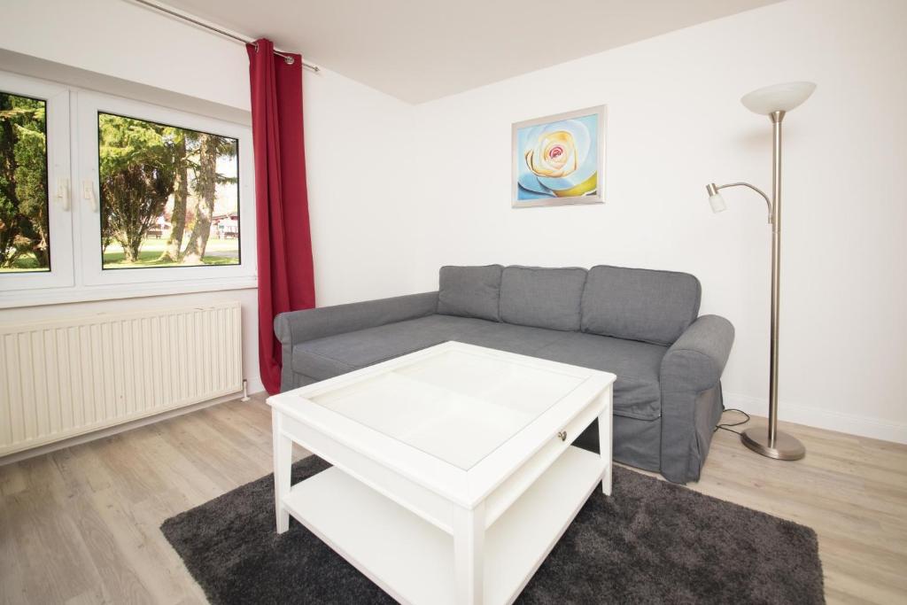 a living room with a couch and a table at Schleiblick App 2 in Rabenkirchen-Faulück