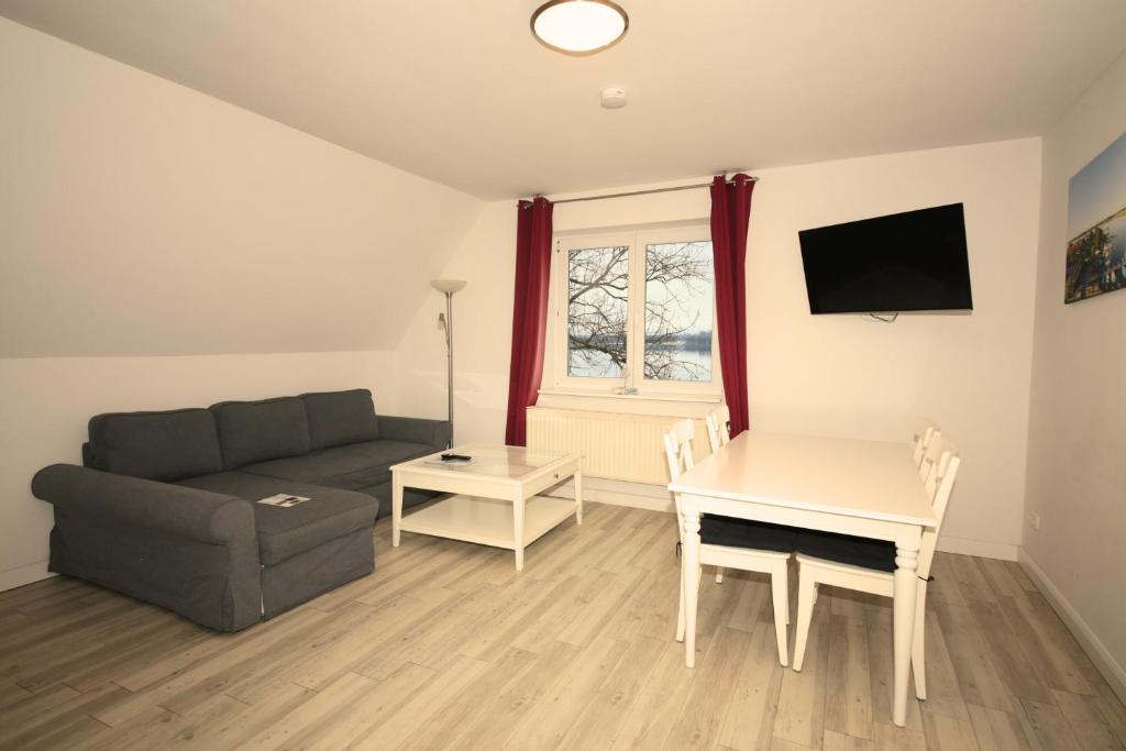 a living room with a couch and a table at Schleiblick App 7 in Rabenkirchen-Faulück