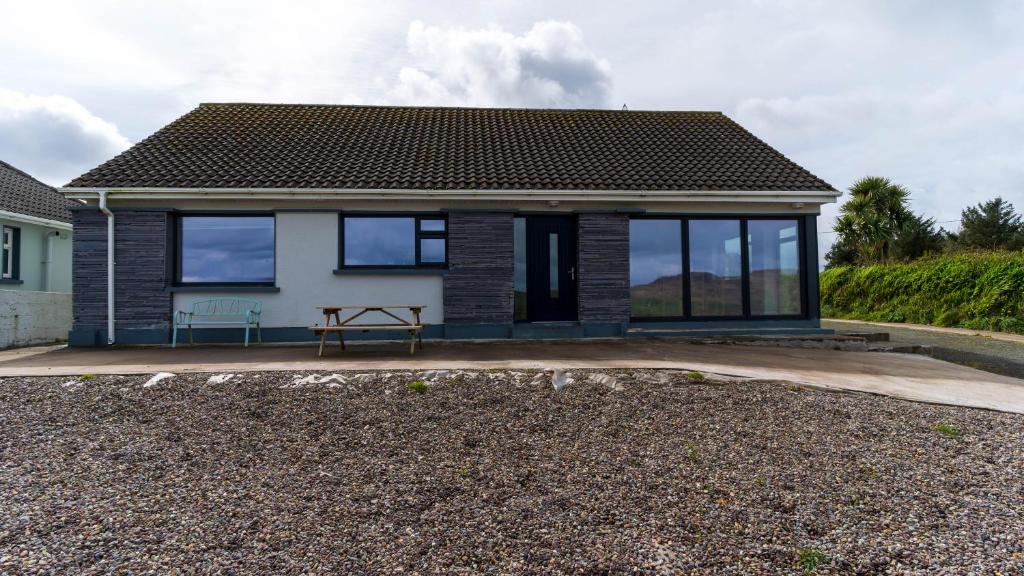 a house with large windows on a driveway at Renard Haven - Cahersiveen in Cahersiveen