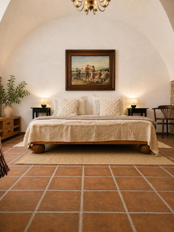a bedroom with a bed with a painting on the wall at Brick House in Fürstenfeld