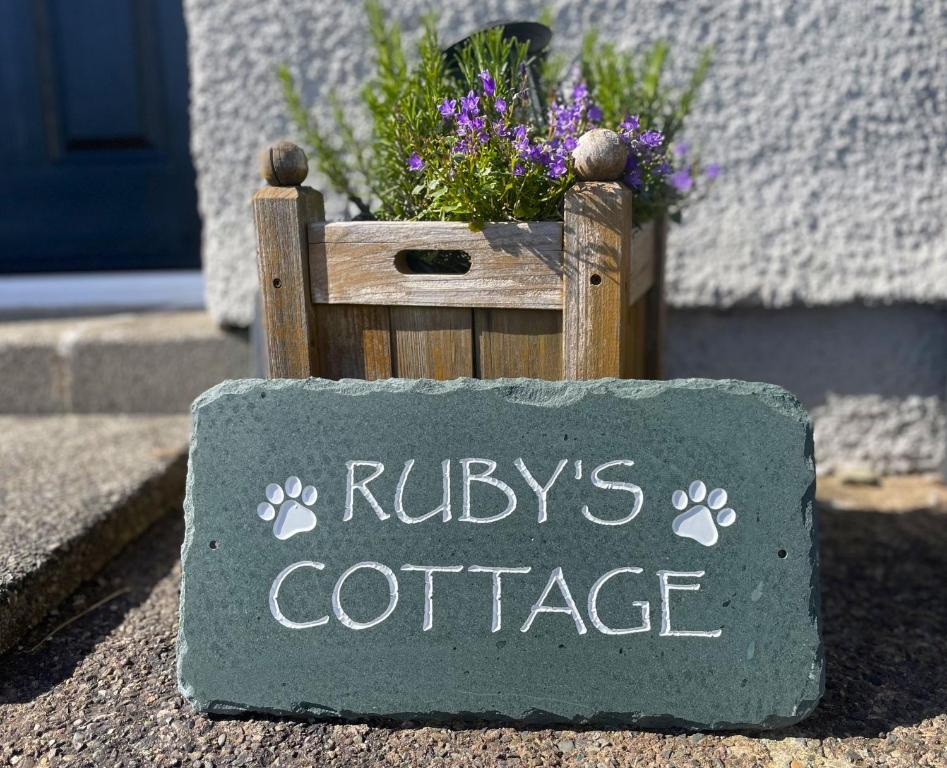 a sign that says rileys cottage with flowers at Ruby's Cottage in Threlkeld