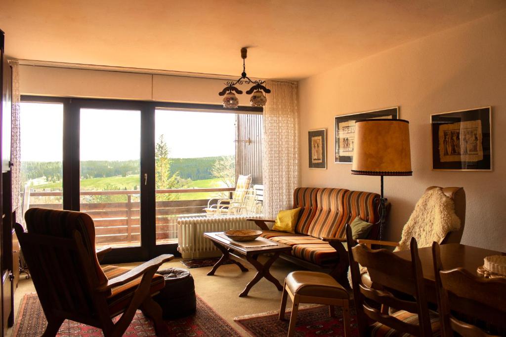 a living room with a couch and a table at Peaceful Oasis Black Forest in Schonach