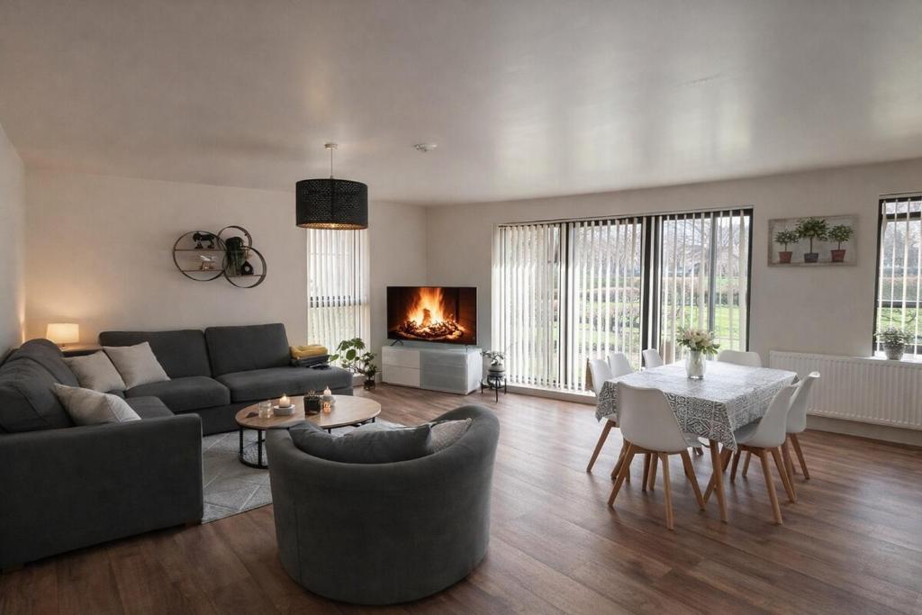 a living room with a couch and a table and a fireplace at Elegant 2-Bed 2-Bath Flat in Edinburgh in Edinburgh