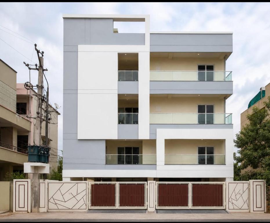 a white building with a fence in front of it at Maruthi inn hotel in Vijayawāda