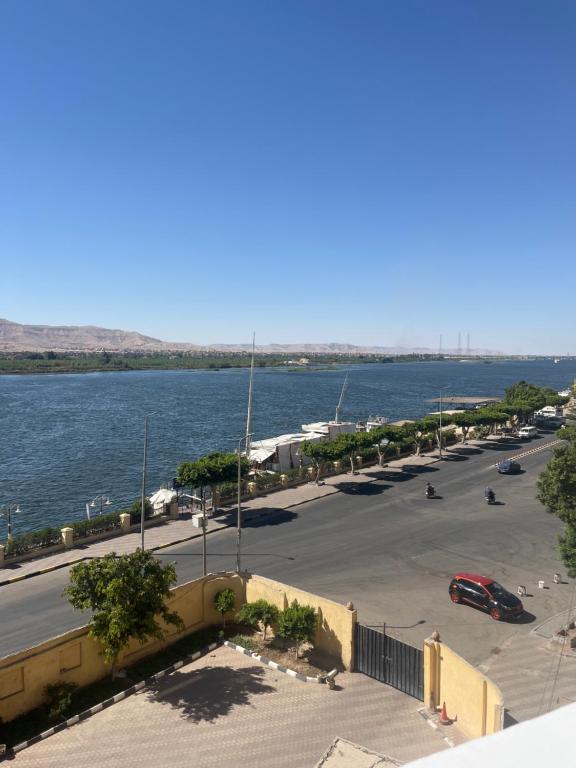 a parking lot next to a body of water at Farida Nile view in Luxor