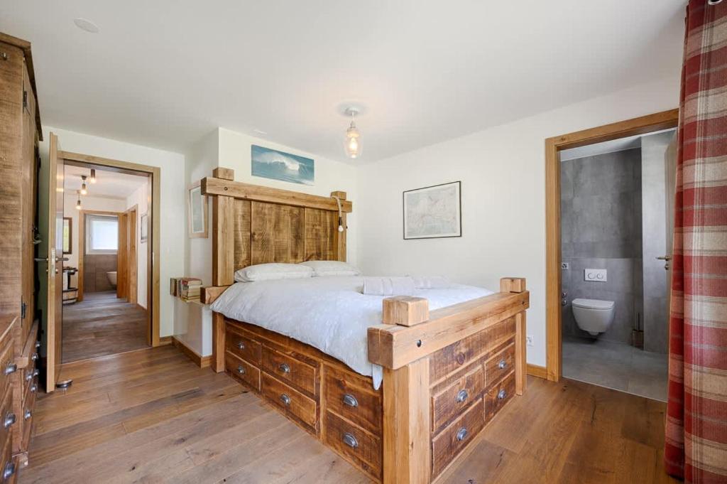a bedroom with a large bed and a bathroom at Matterhorn Panorama Apartment in Zermatt