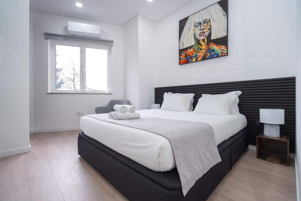 a bedroom with a large bed with a stuffed animal on it at A Casa da Luísa in Vila Real