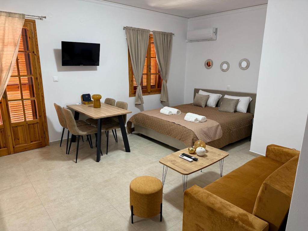 a living room with a bed and a table at Beautiful apartment with mountain view in Paralio Astros