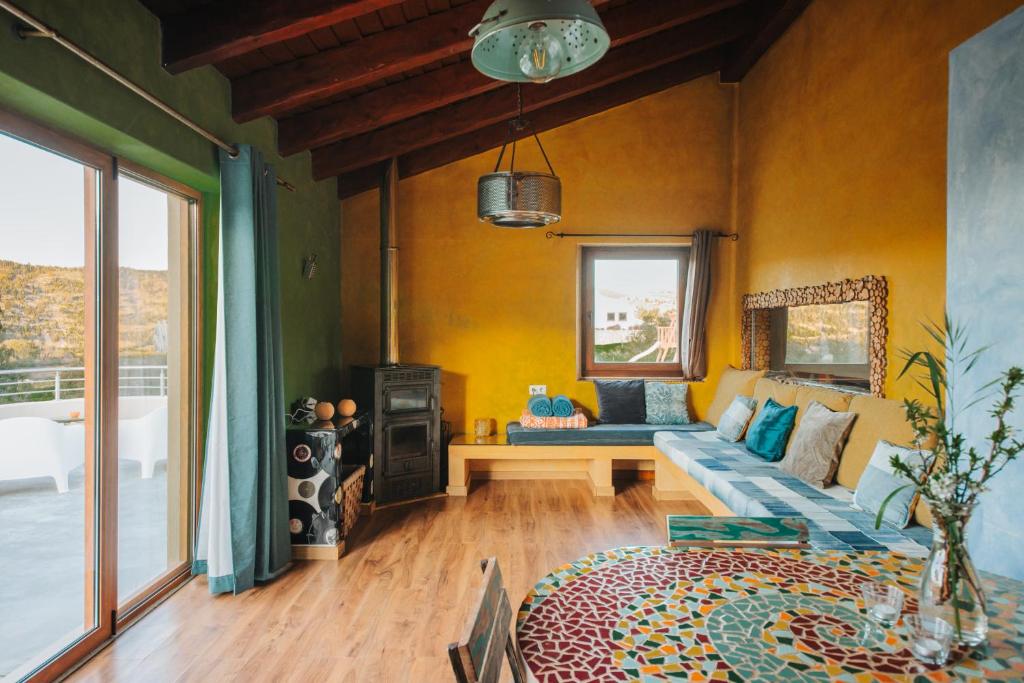 a living room with a couch and a table at Vida Pura Apartments in Odeceixe