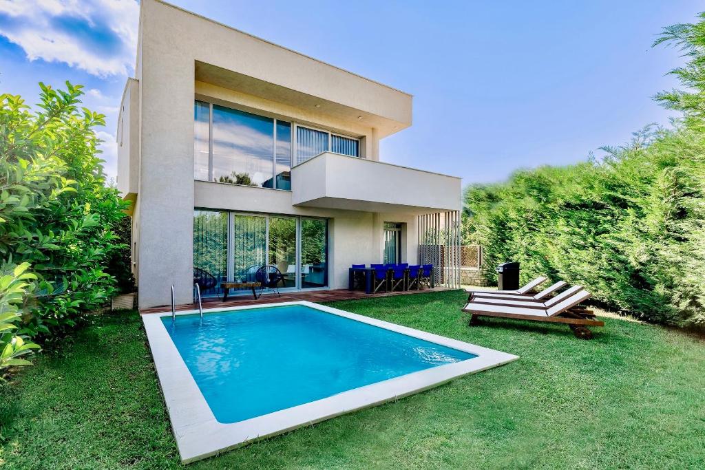 a house with a swimming pool in the yard at SunBlue Boutique Villas in Skala Rachoniou