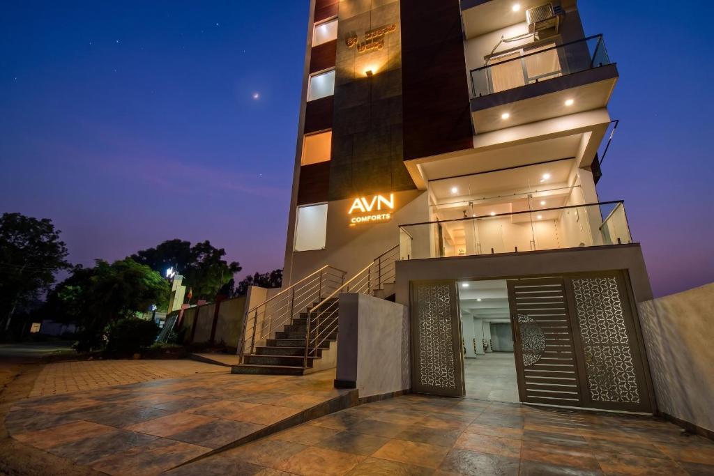 a building with a entrance with a sign on it at AVN Comforts Mysore in Mysore
