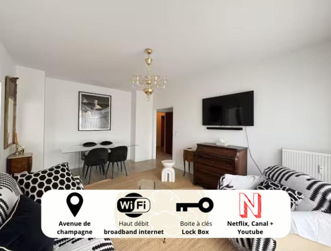 a living room with a couch and a table at Nuit D'or - Cape Champagne - Séjour & Pro in Épernay