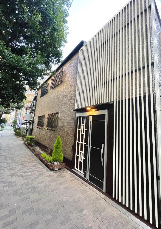 a building with a door in front of it at K-House in Tokyo