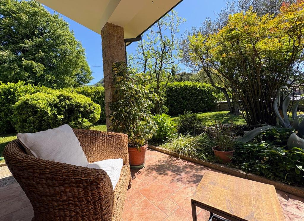 a patio with a wicker chair and a table at Alla Stella B&B in Vo Euganeo