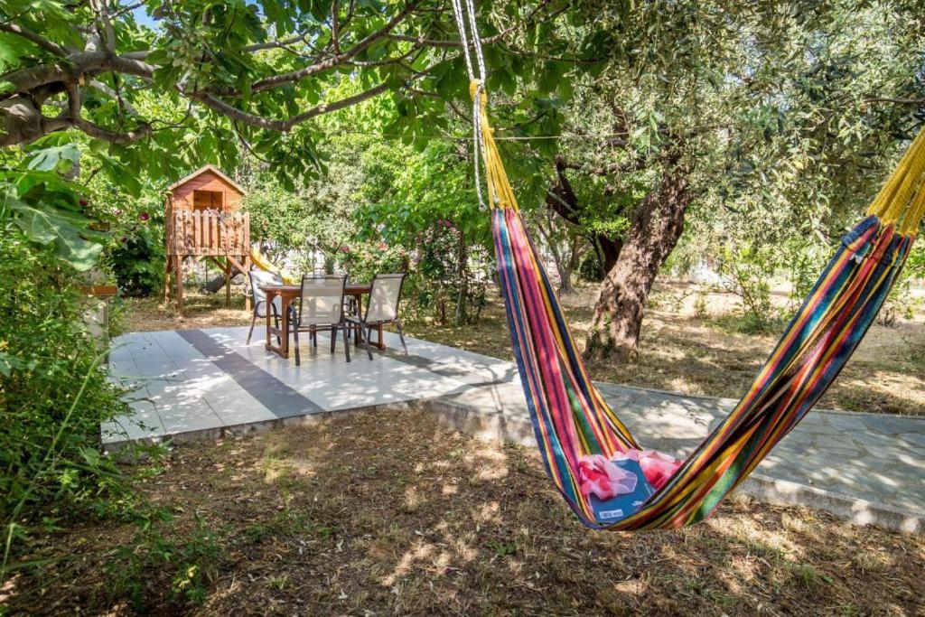 a hammock hanging from a tree in a yard at Andronis in Potos