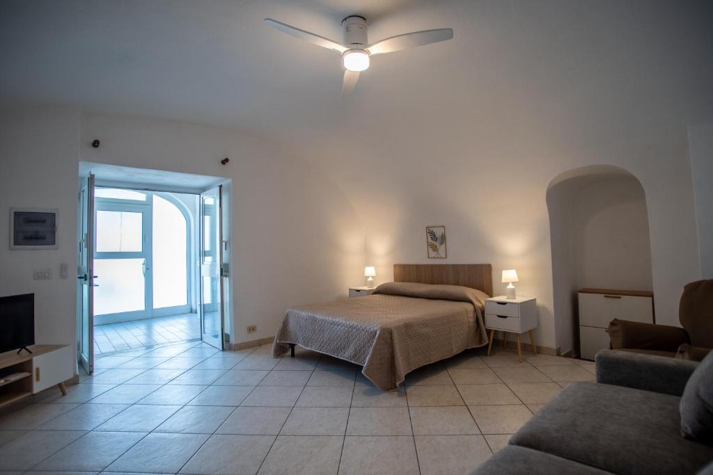 a bedroom with a bed and a ceiling fan at Casa trani in Ischia