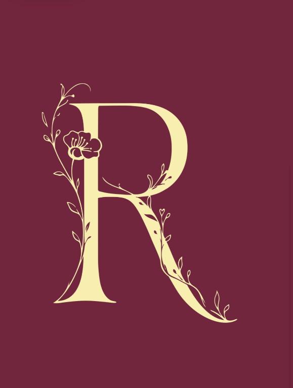 a gold letter p with flowers on a red background at Rubra in Santerno