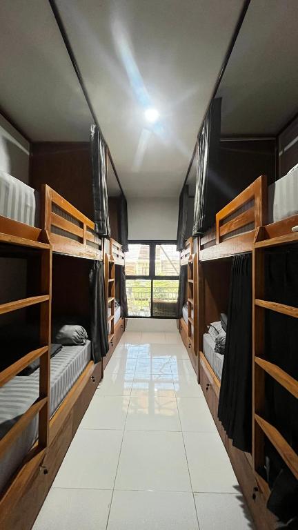 a room filled with lots of bunk beds at TWD hostel in Malang