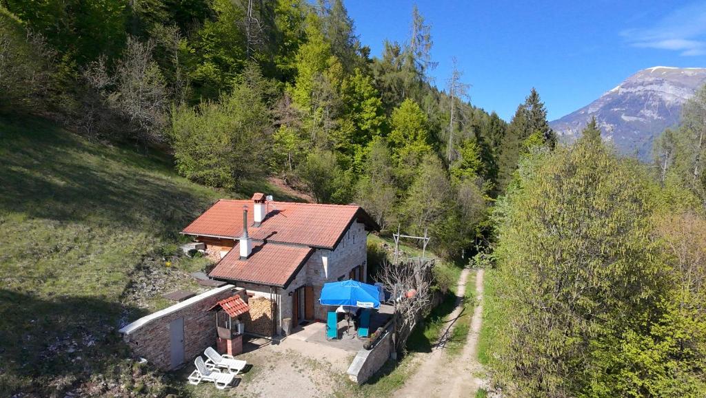 an aerial view of a small house in the mountains at Baita Costa Di Gial in Lamon
