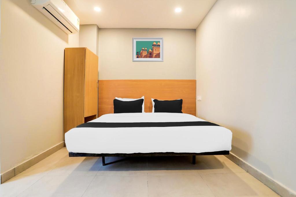 a bedroom with a large bed in a room at Super Collection O RBS ECIL in Hyderabad